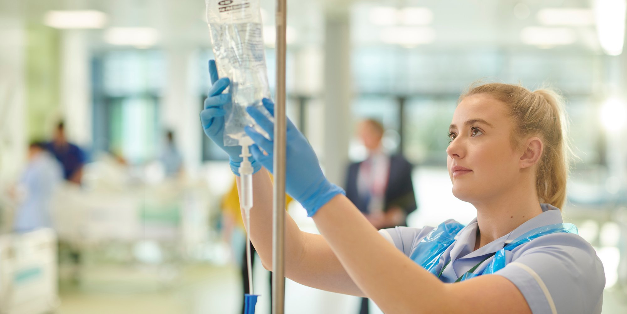 young nurse checks IV drip